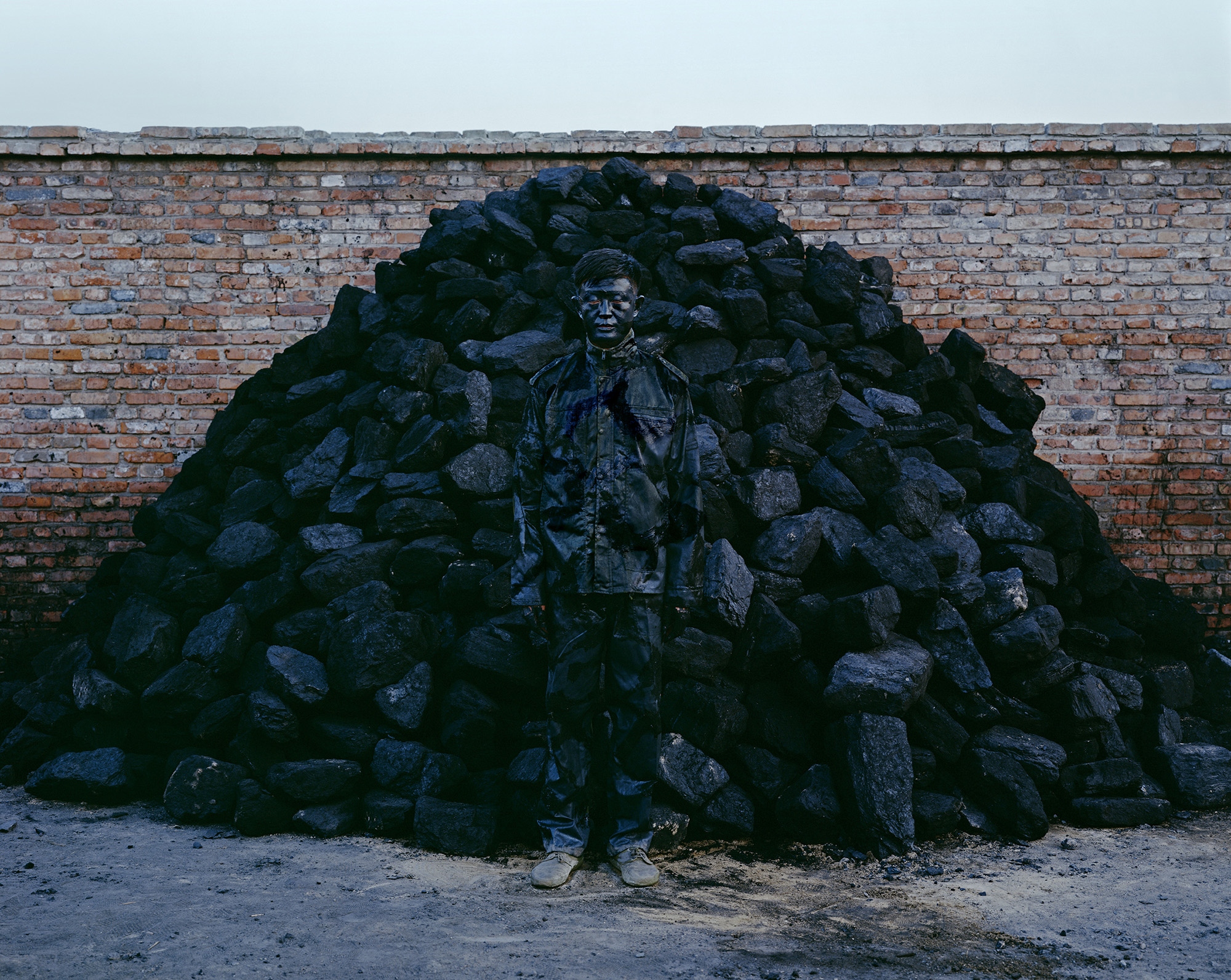 Liu Bolin, Hiding in the City, No. 95, Coal Pile, 2010. Chromogenic print. Loan courtesy of Eli Klein. Image courtesy of Eli Klein and the artist. © Liu Bolin